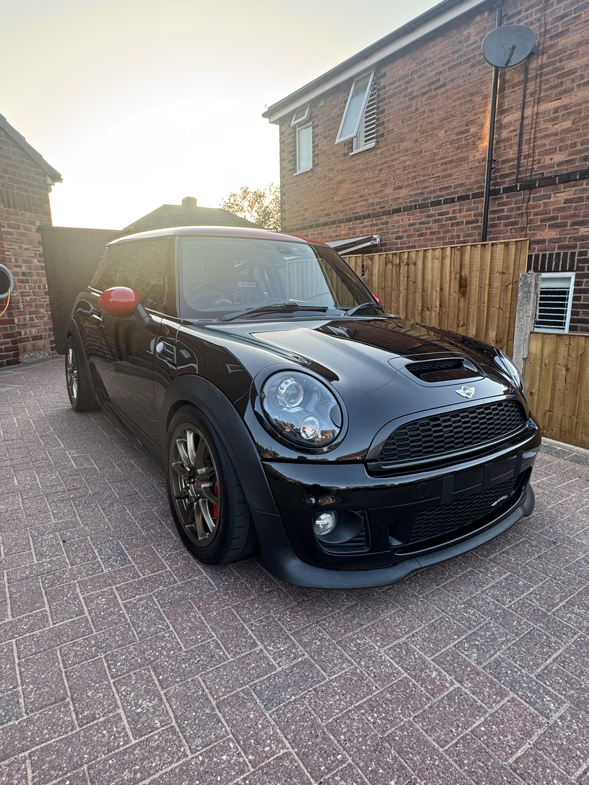 Freshly detailed black MINI Cooper S parked on a driveway in Prescot